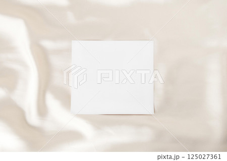 Satin fabric and empty white paper 125027361