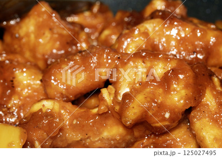 Close up of fried chicken in a sweet and sour chilli sauce Close up of fried chicken in a sweet and sour chilli sauce 125027495