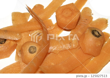 Close up of carrot scrap peelings food waste for compost on white background Close up of carrot scrap peelings food waste for compost on white background 125027513