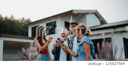 Family toasting with wine during spring family barbecue. 125027564