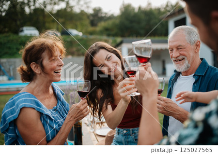 Family toasting with wine during spring family barbecue. 125027565