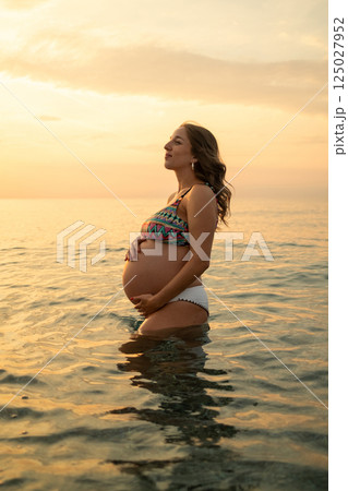 Pregnant Woman Enjoying The Relax Of Sea Water  125027952