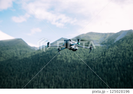 Drone flying in high altitude mountains 125028196