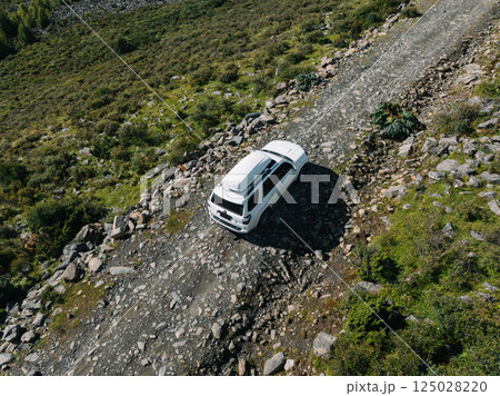 Driving off road car on high altitude mountains 125028220