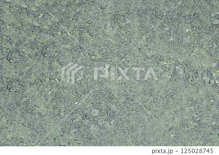 Close-up of an open concrete surface with a filler on which small stones are visible Close-up of an open concrete surface with a filler on which small stones are visible 125028745