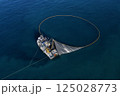 A bird's eye image of a large fishing vessel retrieving its nets.  125028773