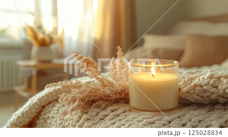 Soft Candlelight on Knit Blanket for Winter Comfort 125028834