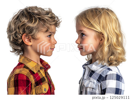 Two adorable children, a boy and a girl, face each other in profile, showcasing their charming expressions and stylish plaid shirts. 125029111