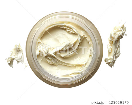 Luxurious cream in a jar, showcasing its rich, creamy texture.  Perfect for beauty, skincare, or cosmetic product advertising.  Clean, minimalist aesthetic evokes feelings of softness and indulgence. 125029179