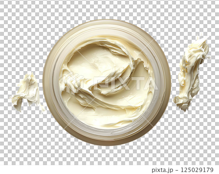 Luxurious cream in a jar, showcasing its rich, creamy texture.  Perfect for beauty, skincare, or cosmetic product advertising.  Clean, minimalist aesthetic evokes feelings of softness and indulgence. 125029179