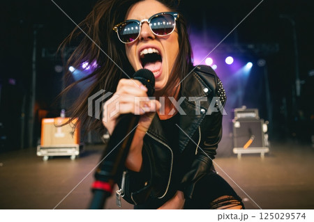 singer on stage singing in the microphone, concert, party, rave singer on stage singing in the microphone, concert, party, rave 125029574