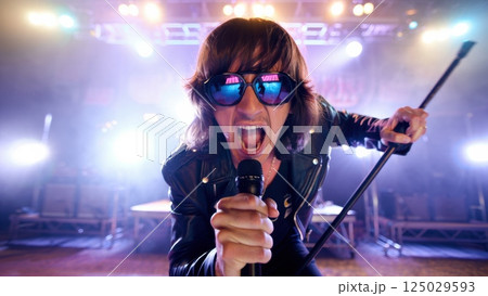 singer on stage singing in the microphone, concert, party, rave singer on stage singing in the microphone, concert, party, rave 125029593