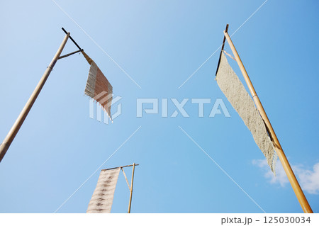 Tung flag on a bamboo pole with blue sky is the arts and culture in northern of Thailand 125030034