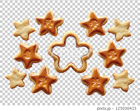 Delicious starshaped cookies, some glazed with caramel, arranged around a cookie cutter.  A festive, sweet image perfect for blogs, holiday baking websites, or food publications. 125030415