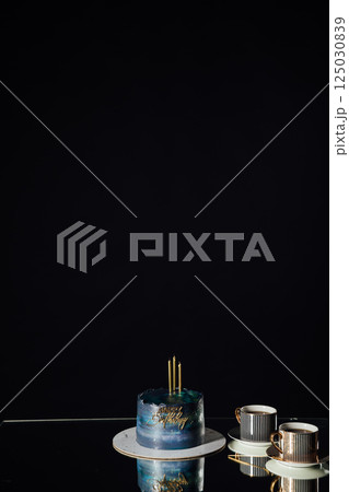 Beautiful Birthday Cake with Candles on a Black Background Beautiful Birthday Cake with Candles on a Black Background 125030839