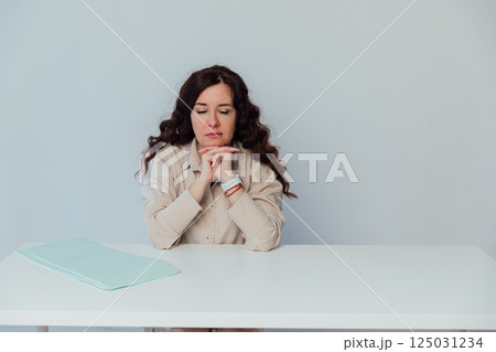 woman sleeping closed her eyes while sitting at office desk 125031234