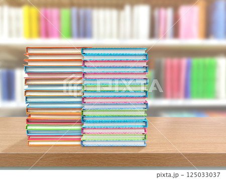 Two stacks of books on a table, blurred library background. Two stacks of books on a table, blurred library background. 125033037