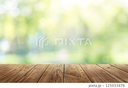 Wooden table and backyard blurred background Wooden table and backyard blurred background 125033876