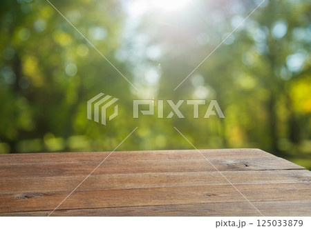 Wooden table and natural blurred background 125033879