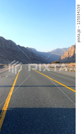 Colorful mountains highlight unique geology, mountains framing paved highway, popular tourist destination , encouraging adventure travel, memorable adventure awaits. Road in mountains Colorful mountains highlight unique geology, mountains framing paved highway, popular tourist destination , encouraging adventure travel, memorable adventure awaits. Road in mountains 125034159
