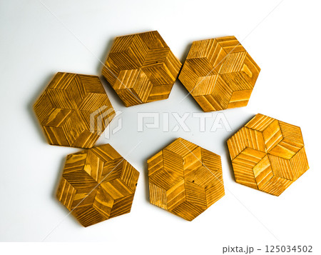 Six wooden hot plate stands in hexagon shape isolated on white background Six wooden hot plate stands in hexagon shape isolated on white background 125034502