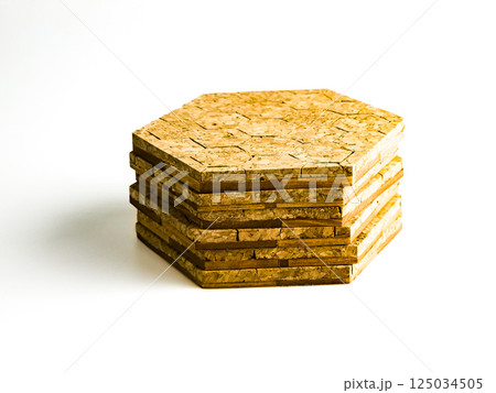 Stack of cork hot pads in hexagon shape isolated on white background 125034505