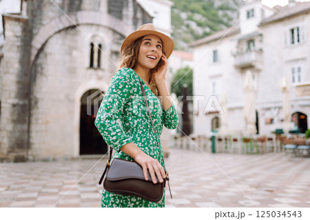 Young woman in beautiful dress walking in the street of the city. Eurotrip. Travel, tourism. Fashion 125034543
