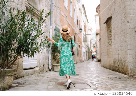 Young woman in beautiful dress walking in the street of the city. Eurotrip. Travel, tourism. Fashion 125034546