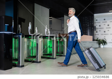 Male traveler walking towards security gates preparing for business trip Male traveler walking towards security gates preparing for business trip 125034686
