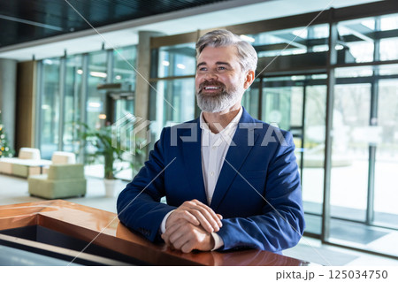 Bearded man entrepreneur standing at business hub reception counter 125034750