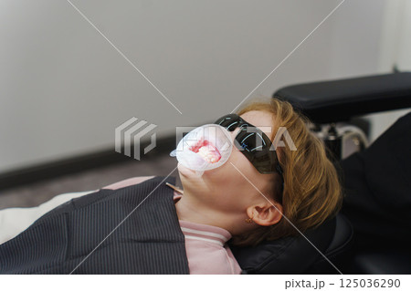 Professional dental hygiene treatment for children in a dental office setting 125036290