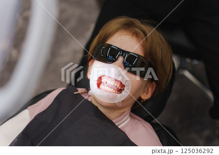 Professional dental hygiene for children in a dental clinic setting 125036292