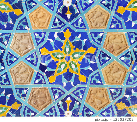 Old tiles background. Vintage colored ceramics with a pattern on the facade 125037205