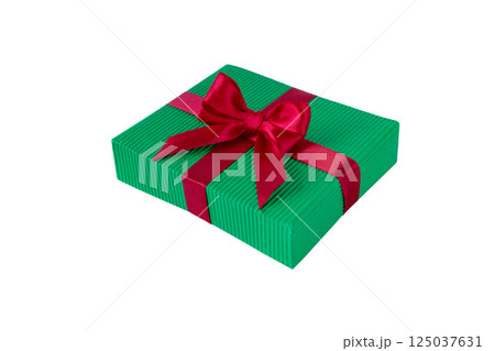 Christmas gift box with satin bow isolated on white. Green gift box tied with red silk ribbon. 125037631