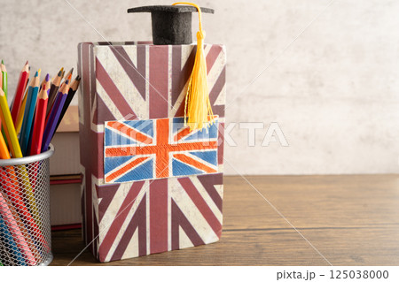 UK flag with graduate hat on english language book. 125038000