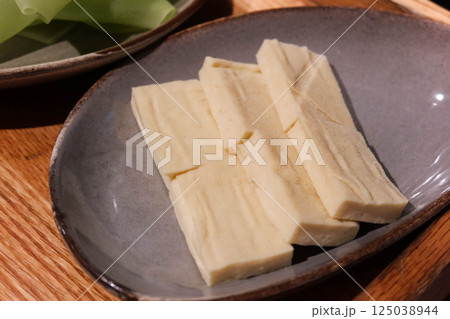 close up of uncooked raw tofu ( bean curd) cut in rectangle on a plate shape for hot pot 125038944