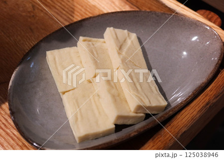 close up of uncooked raw tofu ( bean curd) cut in rectangle on a plate shape for hot pot close up of uncooked raw tofu ( bean curd) cut in rectangle on a plate shape for hot pot 125038946