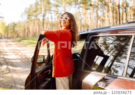 Stopping during a car trip. Young woman enjoying nature. Journey by car. Lifestyle, travel, tourism 125039273