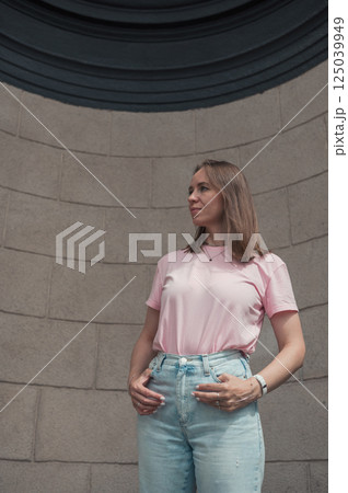 Casual Young Woman Leaning Against Stone Wall Casual Young Woman Leaning Against Stone Wall 125039949