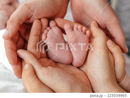 A newborn baby's feet in mom s hands close-up. High quality photo A newborn baby's feet in mom s hands close-up. High quality photo 125039993