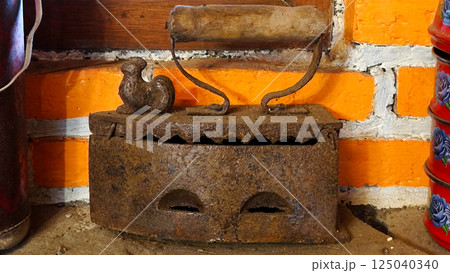 Vintage Iron Press on Rustic Brick Wall Background Indonesian Traditional House Vintage Iron Press on Rustic Brick Wall Background Indonesian Traditional House 125040340