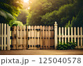 Golden Hour Glow on Rustic Wooden Gate Amidst Lush Greenery 125040578