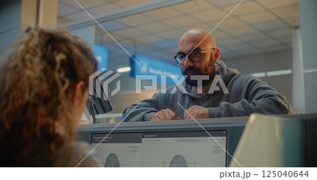 Man Giving Documents and Airplane Ticket, Verifying Biometric Data by Scanning Fingerprint 125040644
