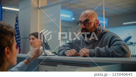 Man Giving Documents and Airplane Ticket, Verifying Biometric Data by Scanning Fingerprint 125040645