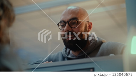 Airport Check-in Counter: Close Up of Man Talking to Airline Agent During Passport Check 125040675