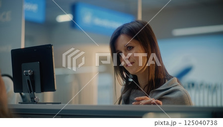 Check-in Counter: Close Up of Woman Talking to Airline Worker, Waiting for Passport Check 125040738
