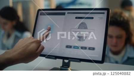 Airport Check-in Counter: Close Up of Indian Tourist Putting Finger on Touch Screen for Fingerprint Scanning 125040882