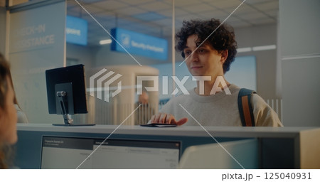 Airport Check-in Counter: Indian Man Verifying Personal ID Data by Facial Recognition Scanning Airport Check-in Counter: Indian Man Verifying Personal ID Data by Facial Recognition Scanning 125040931