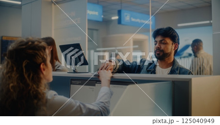 Check-in Counter: Indian Man Giving Documents to Airline Agent, Scanning Fingerprint 125040949