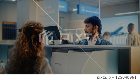 Check-in Counter: Indian Man Giving Documents to Airline Agent, Scanning Fingerprint 125040961